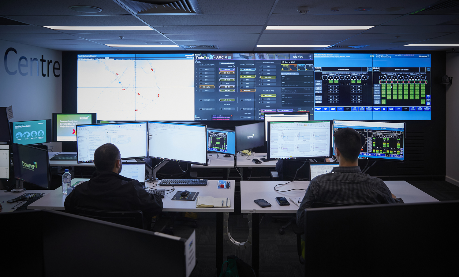 Rail network controllers in front of computer screens
