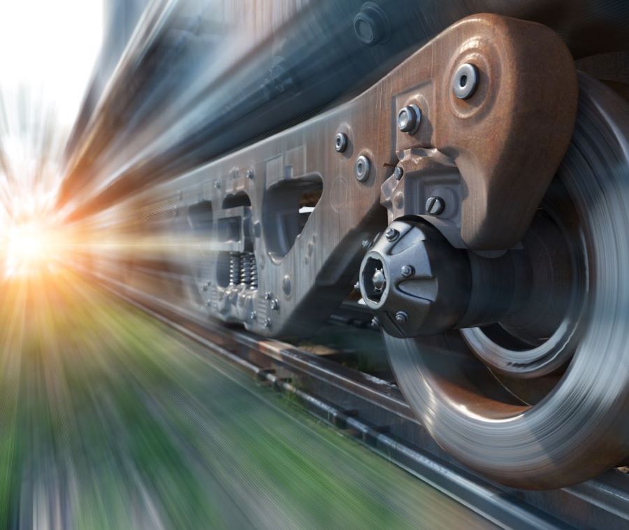 Close up shot of train wheels speeding along a track